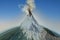 Colossal three-dimensional volcano peak in Mexico called Popocatepetl covered with snow, in activity expelling column of steam,