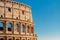 Colosseum or Coliseum ancient ruins background blue sky Rome, Italy