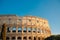 Colosseum or Coliseum ancient ruins background blue sky Rome, Italy