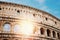 Colosseum or Coliseum ancient ruins background blue sky Rome, Italy, stone arches and sunset