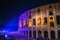 Colosseum or Coliseum wall with night illumination. Huge Roman amphitheatre in Rome, Italy