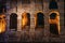 Colosseum or Coliseum wall with night illumination. Huge Roman amphitheatre in Rome, Italy