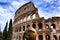 Colosseum famous architectural monument close-up in the daytime on the clouds background. Rome, Italy.