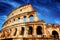 Colosseum in Rome, Italy. Amphitheatre over deep blue sky