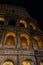 Colosseum in rome at night with illuminated arches
