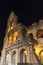 Colosseum in rome at night with illuminated arches