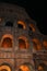 Colosseum in rome at night with illuminated arches
