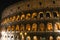 Colosseum in rome at night with illuminated arches