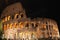 Colosseum in rome at night with illuminated arches