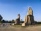 The Colossi of Memnon are two massive stone statues of Pharaoh Amenhotep III.