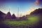 Colour picture of haystacks on a hill in a village