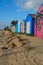 Coloured Boat sheds on beach.