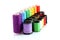 Coloured bobbins of thread isolated