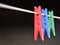 Coloured clothes pegs on washing line