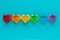Coloured hearts in a row on a blue background. LGTB+ concept. Valentine`s Day. Copy space