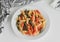 Coloured Italian wheat pasta on a white plate. Healthy food