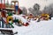 Coloured playground in winter, looks abandoned under snow