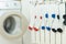 Coloured socks drying on the heating radiator next to the washing machine. Concept of housework