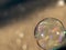 Coloured translucent soap bubble floating in the air