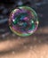 Coloured translucent soap bubble floating in the air
