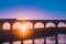 Colourful aerial view of sunrise with train travelling on Arthington Viaduct, UK