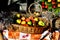 Colourful apples and nuts in a wooden basket on a table with old retro farming objects- autumn still life