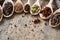 Colourful aromatic various spices for cooking on old wooden barrel, close-up, flat lay, selective focus, copy space.