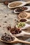 Colourful aromatic various spices for cooking on old wooden board, close-up, flat lay, selective focus.