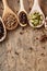 Colourful aromatic various spices for cooking on old wooden board, close-up, flat lay, selective focus, copy space.