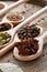 Colourful aromatic various spices for cooking on old wooden board, close-up, flat lay, shallow depth of field.