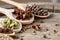 Colourful aromatic various spices for cooking on old wooden board, close-up, flat lay, shallow depth of field.