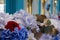 Colourful artificial flowers photographed outside a store in the piazza at Covent Garden historic market, London UK.