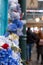 Colourful artificial flowers photographed outside a store in the piazza at Covent Garden historic market, London UK.