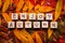 Colourful autumn leaves on grey wood with the words enjoy autumn on wooden blocks