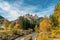 Colourful autumn picture of the Sella massif mountains and the Avisio river in the village Alba di Canazei