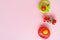 Colourful baby rattles on pink background. Toys for infants, baby goods. Copy space