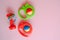 Colourful baby rattles on pink background. Toys for infants. Top view.