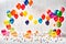 Colourful balloons against a vibrant white background - AI Generated