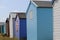Colourful beach hut dwelling in a row on beach front.family holiday and storage icon
