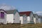 Colourful beach hut dwelling in a row on beach front.family holiday and storage icon