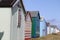 Colourful beach hut dwelling in a row on beach front.family holiday and storage icon