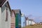 Colourful beach hut dwelling in a row on beach front.family holiday and storage icon