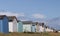 Colourful beach hut dwelling in a row on beach front.family holiday and storage icon