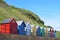 Colourful beach sheds.