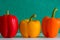 Colourful bell peppers in front of a colourful background