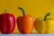 Colourful bell peppers in front of a colourful background