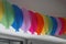 Colourful Birthday Garland on the white wall above the window.  Let`s party. Birthday wall decoration. Holiday deco paper chain o