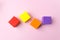 Colourful blocks smockup on pink background, Bricks mockup, copy space. Empty stack of cubes for creative design. Scattered