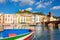 Colourful boat on background of beautiful buildings of Bosa, Sardinia, Italy