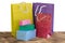 Colourful and bright shopping packages and boxes on wooden background
